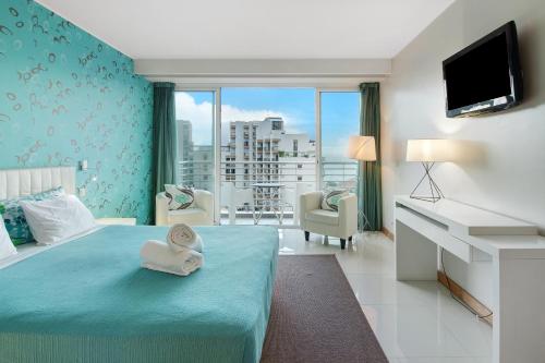 a hotel room with a bed with towels on it at Dfm Happy Days E - Funchal in Funchal