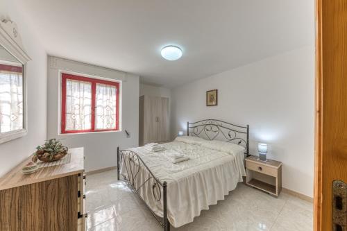a bedroom with a bed and a table in it at Pilella in Alliste