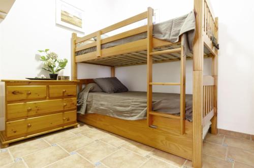 a bedroom with a bunk bed and a dresser at Vistas a Moraira in Teulada