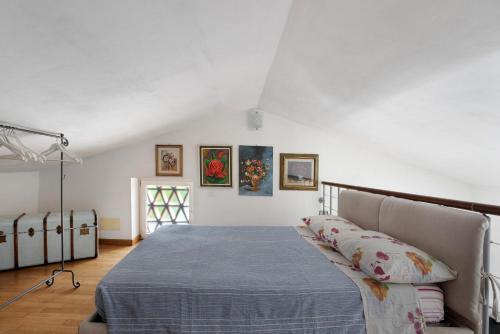 a bedroom with a bed with a blue blanket at La Vigna - Tra 5 terre e Versilia in Sarzana