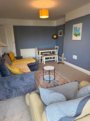 a living room with a couch and a table at Dickens HideAway in Hollington