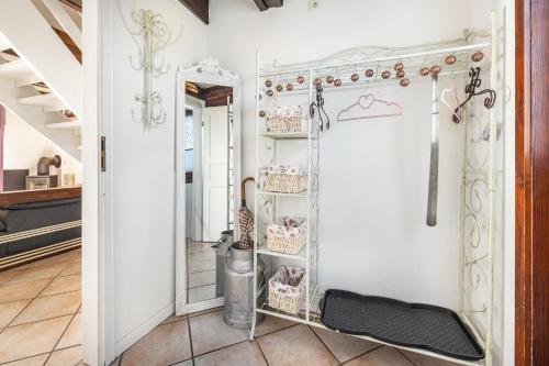 a dressing room with a mirror and a shelf with utensils at Arosa in Bachenbrock