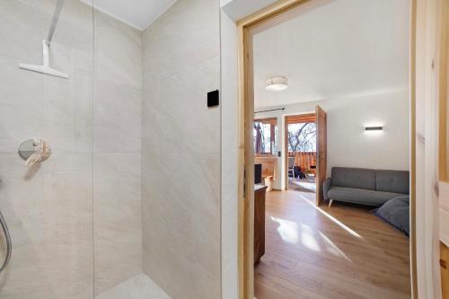 a bathroom with a shower with a glass door at Hauserhof in Lagundo