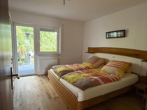 a bed in a room with a window at Casa Jo und Jo in Pfullendorf