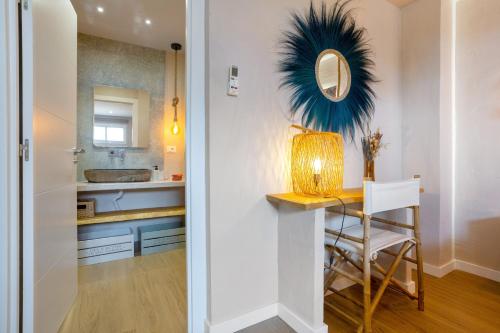 a bathroom with a table with a mirror and a sink at Oceania Villa B, Private Pool in Chayofa