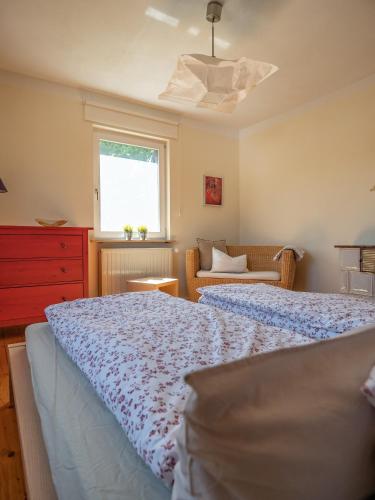 a bedroom with a bed and a window and a couch at altes forsthaus schotten in Schotten