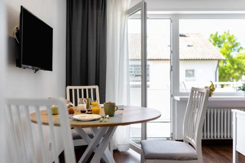 a dining room with a table and chairs and a window at Andrea in Langenargen