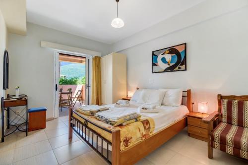 a bedroom with a bed and a balcony at Apollon Apartment in Póndi