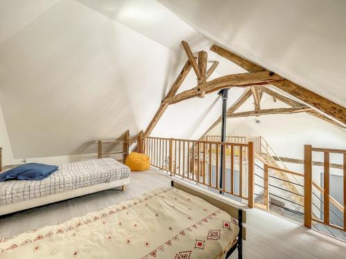 a bedroom with two beds and a staircase at Maison authentique et au calme in Beynat