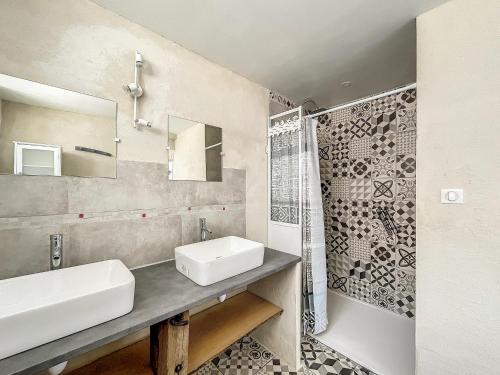 a bathroom with a sink and a mirror and a shower at Maison authentique et au calme in Beynat