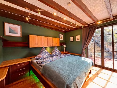 a bedroom with a large bed in a room at The red House in Schönecken