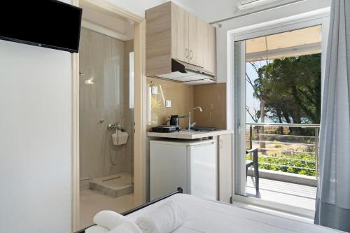 a small kitchen with a sink and a bathroom at Iguana studio 7 in Preveza