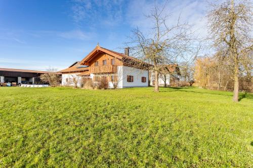 a house with a green field in front of it at Haus am Hof in Kirchseeon