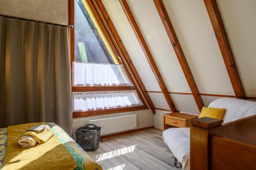 a room with two beds and a window at Gite Gewurz n°4 à Kaysersberg in Kaysersberg