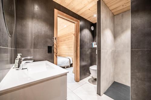 a bathroom with a sink and a toilet at Martonne Terrasse chatel Roca in Châtel