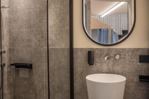 a bathroom with a sink and a shower at Avia Living Maria in Brunico