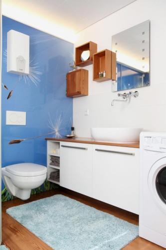 a bathroom with a sink and a washing machine at Gästehäusle Haag in Waldshut-Tiengen