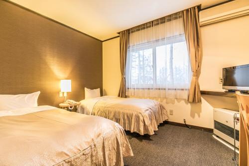 Postel nebo postele na pokoji v ubytování Petit Hotel Enchante