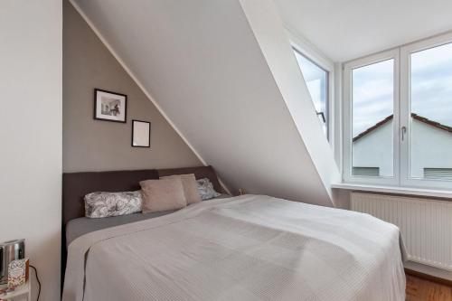 a bedroom with a bed and a large window at Skyline-Blick in Bad Soden am Taunus