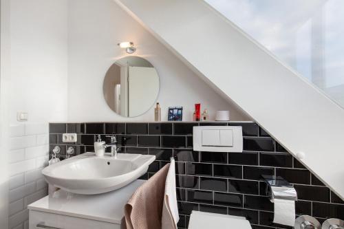 a bathroom with a sink and a mirror at Skyline-Blick in Bad Soden am Taunus
