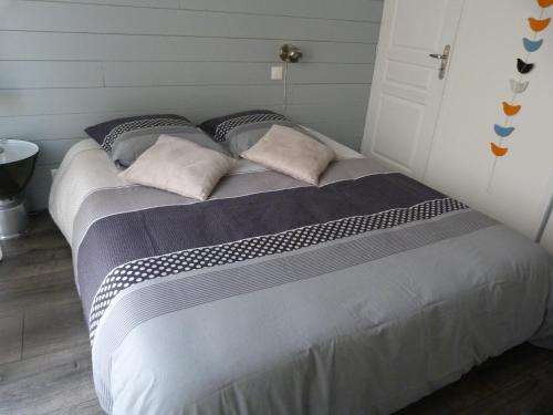 a large bed with two pillows in a bedroom at La Chambre aux Oiseaux in Cayriech