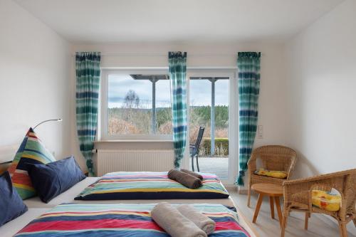 a bedroom with two beds and a window at Haus Intlekofer in Lenzkirch