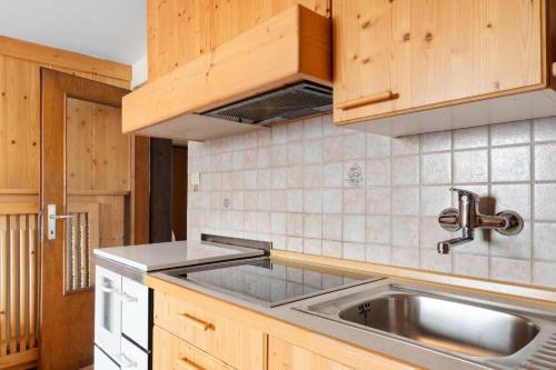 a kitchen with wooden cabinets and a sink at Haus Prossliner in Tesimo