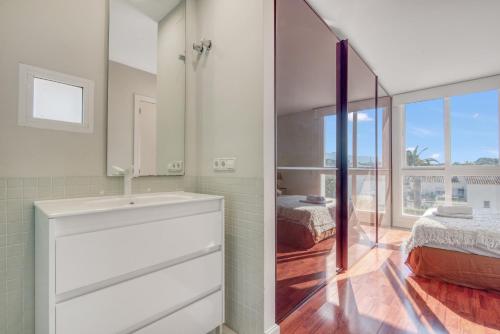 a bathroom with a sink and a mirror at Traviata in Cap Blanc