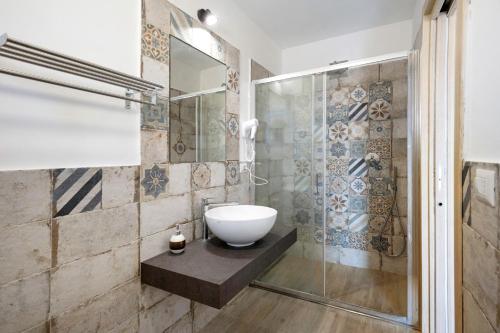 a bathroom with a sink and a glass shower at Bed And Breakfast Il Ceppo Wild in Pimonte