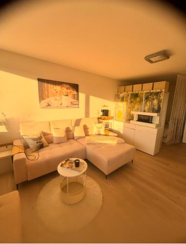a living room with a couch and a table at Über den Dächern von Aachen in Aachen