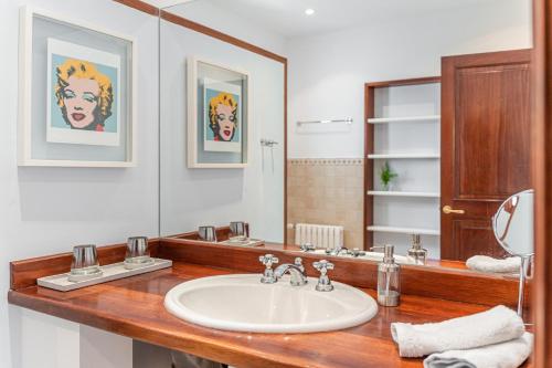 a bathroom with a sink and a mirror at Casa del Puerto in Port de Soller