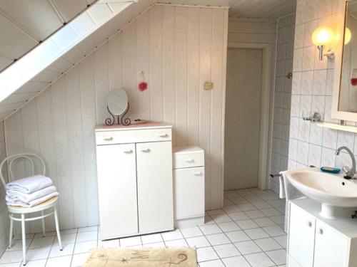 a white bathroom with a sink and a staircase at Gästehaus Schlamau19 in Schlamau