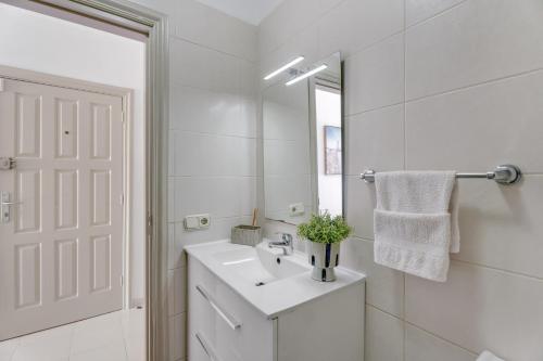 a white bathroom with a sink and a mirror at Seaview las Americas in Adeje