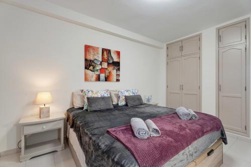 a bedroom with a large bed with towels on it at Seaview las Americas in Adeje
