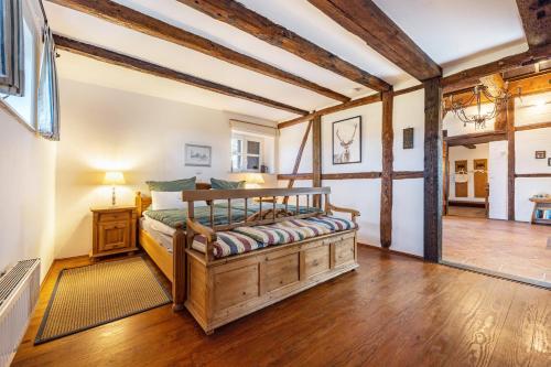 a bedroom with a wooden bed in a room at Ferienwohnung Juttashof in Camin