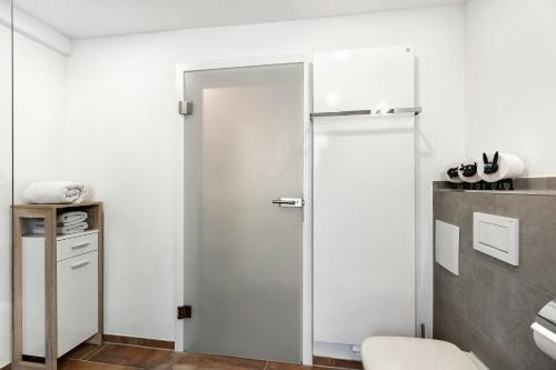 a bathroom with a white door in a room at Ferienwohnung Donauherz in Stetten