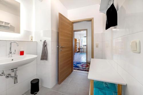 a bathroom with a sink and a toilet and a door at Rheinferien in Kamp-Bornhofen