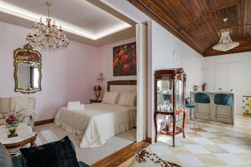 a bedroom with a bed and a chandelier at W430 Guimarães in Guimarães