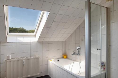 a bathroom with a bath tub and a window at Gutshaus am Teich in Neukloster