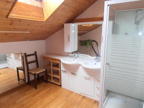 a bathroom with a sink and a mirror and a chair at Chalet St Victoire - Les Orres in Les Orres