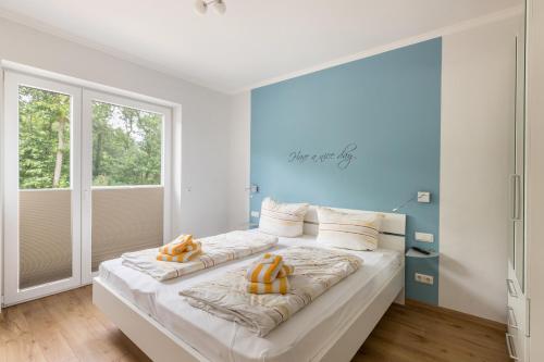 a bedroom with a large bed with orange pillows on it at Ferienhaus Manni Eg in Büsum