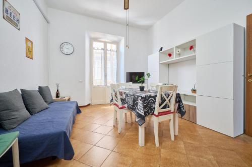 a living room with a couch and a table with chairs at Casabaffo in Piombino