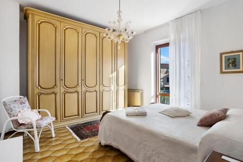 a bedroom with a large bed and a chair at Casa Vanda - 5 Terre in Arcola