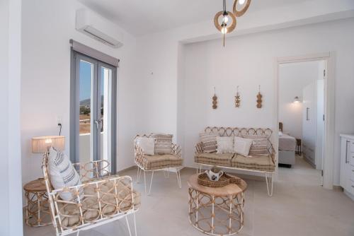 a living room with a couch and chairs and a table at Villa Anastasio in Kampos Paros