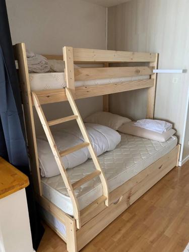 a wooden bunk bed in a small room at Résidence l'olympia in Montgenèvre