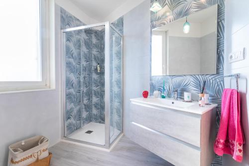 a bathroom with a shower and a sink and a mirror at Sole e Girasoli in Molfetta