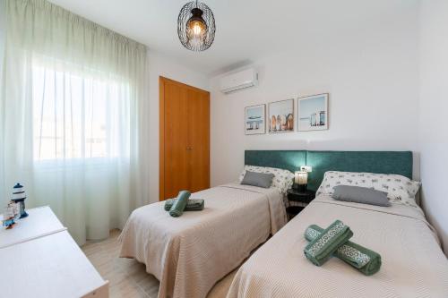 a bedroom with two beds and a window at Rincon de Almerimar Palm Beach Golf in Almerimar