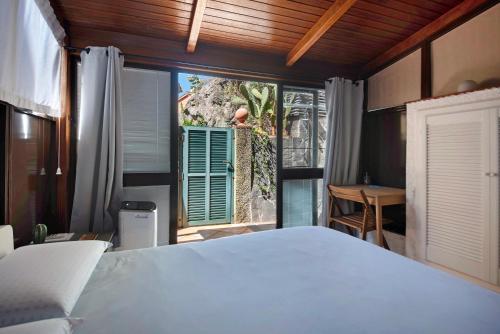 a bedroom with a bed and a large window at Terrazza Sivori in Bonassola