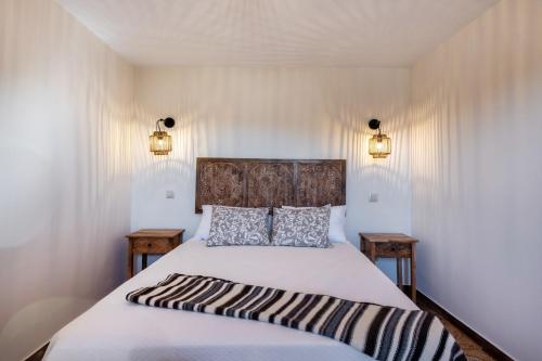 a bedroom with a large bed with a wooden headboard at Alte Com Amor in Alte