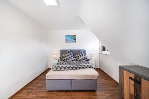 a bedroom with a bed with two pillows at Schorsch's Ferienhaus in Winzeln